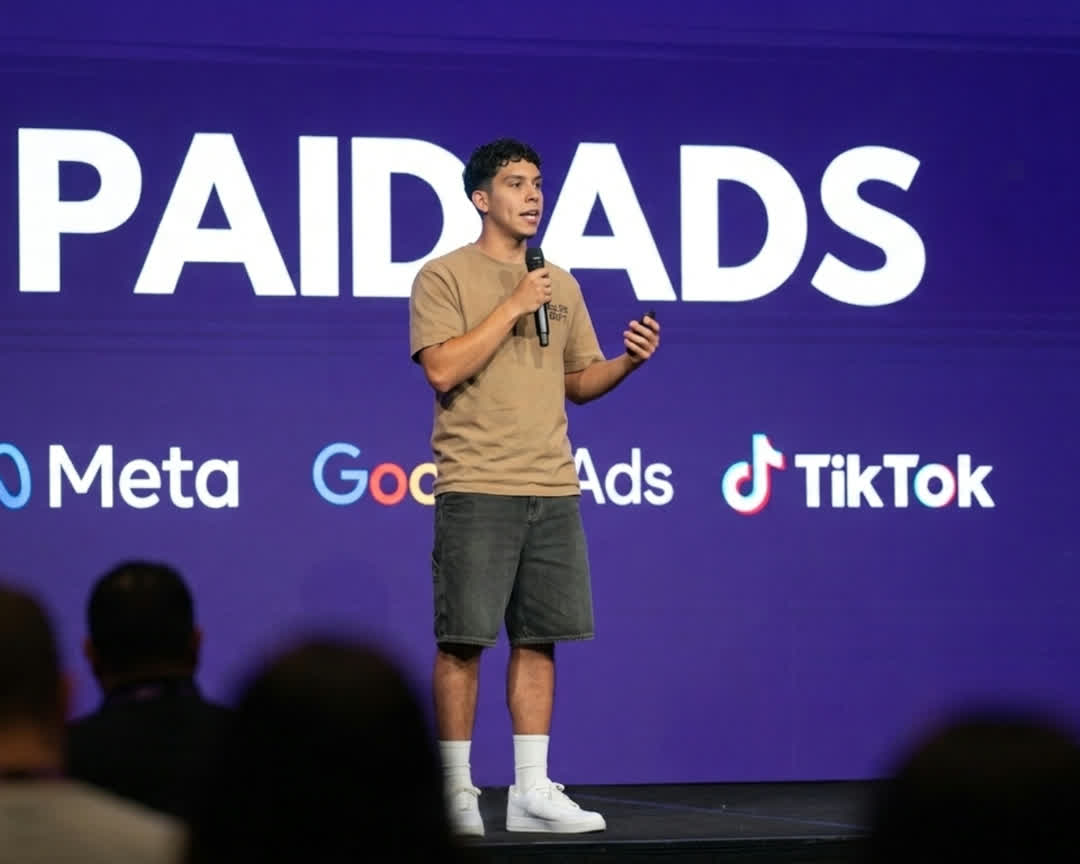 Mark Arceo speaking on stage at a marketing event, presenting on paid ads across Meta, Google, and TikTok